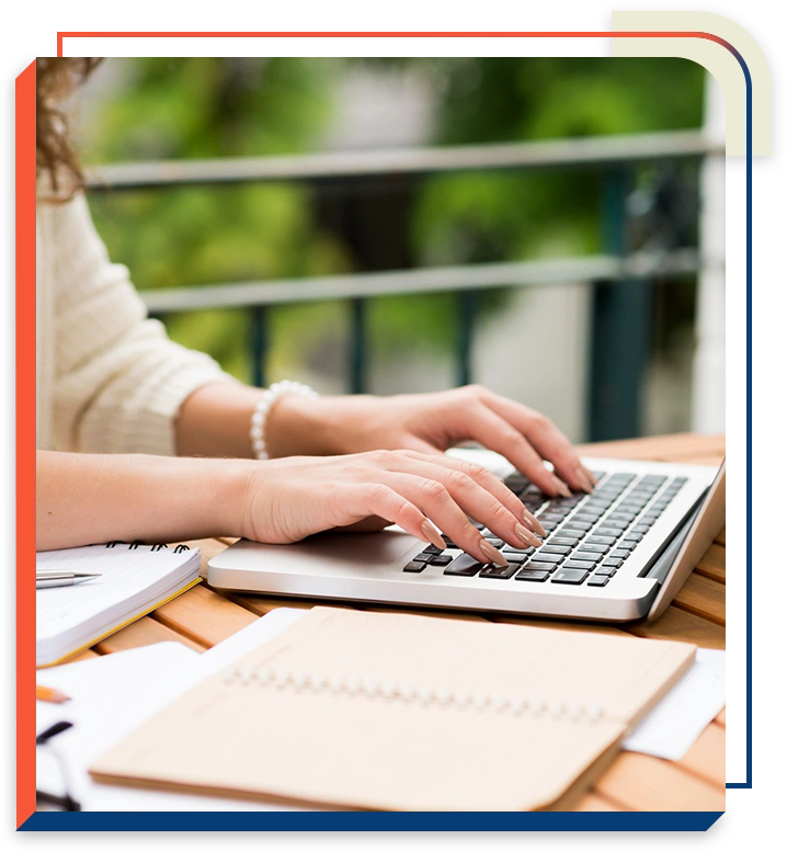 1 A person typing on a laptop computer.