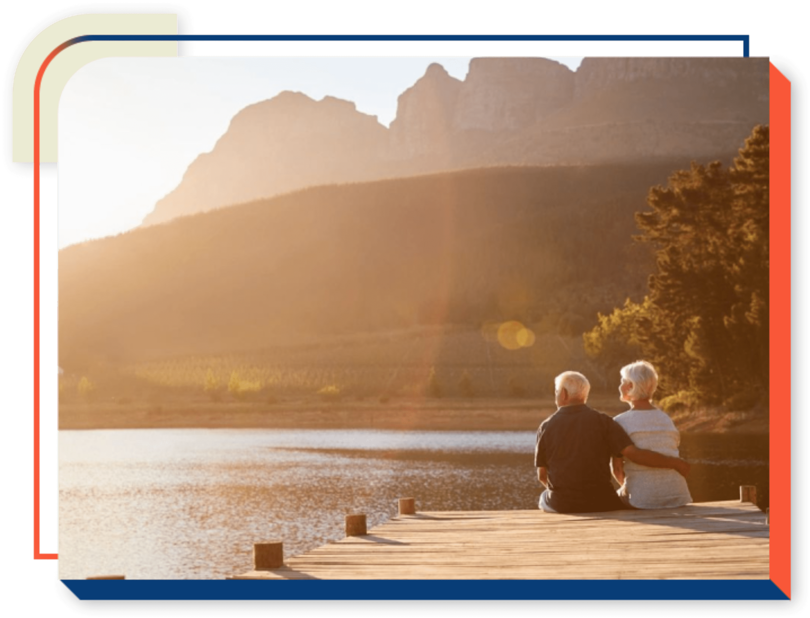 A couple sitting on the edge of a pier.