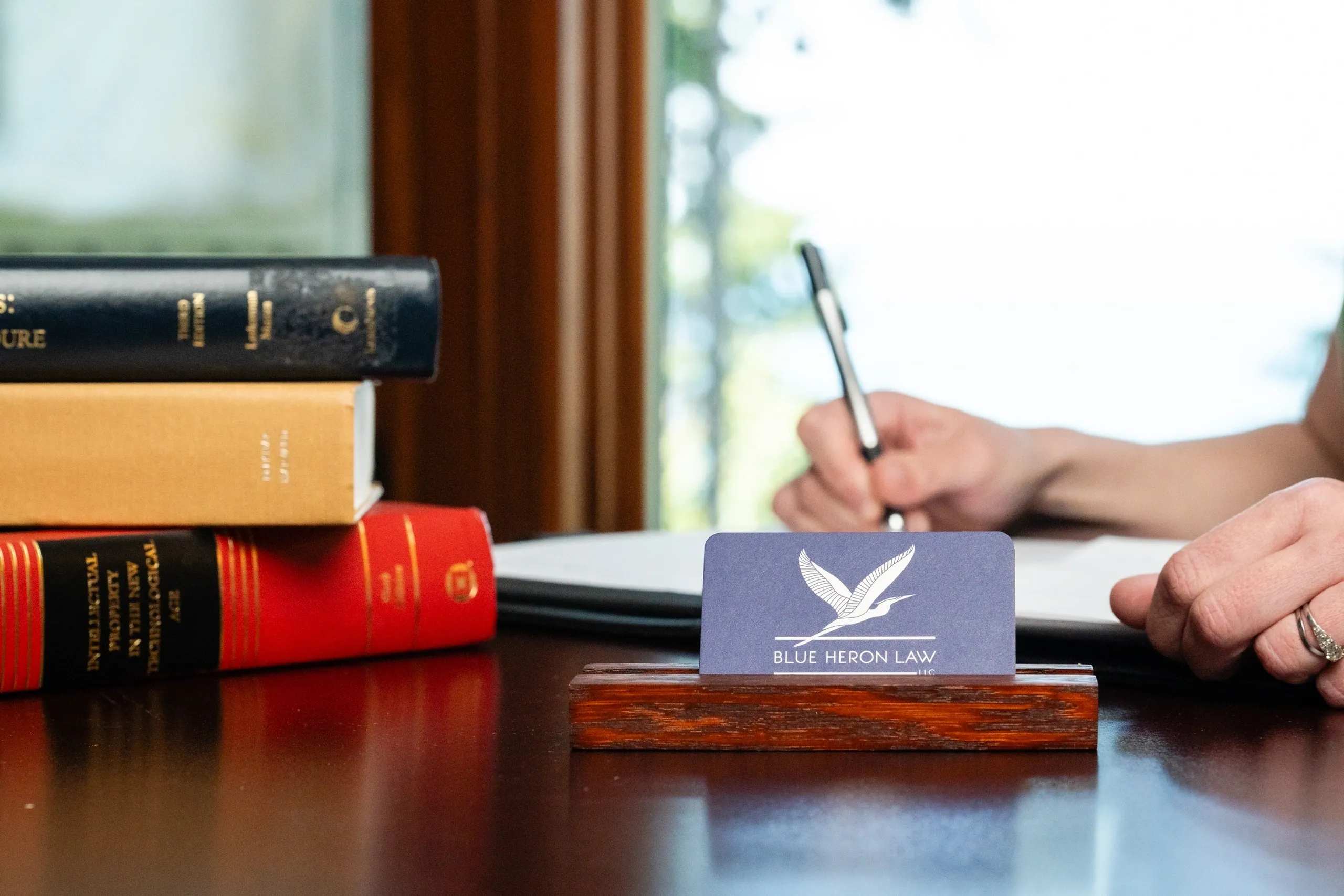 Cover_A7407173 A person writing on a desk with some books